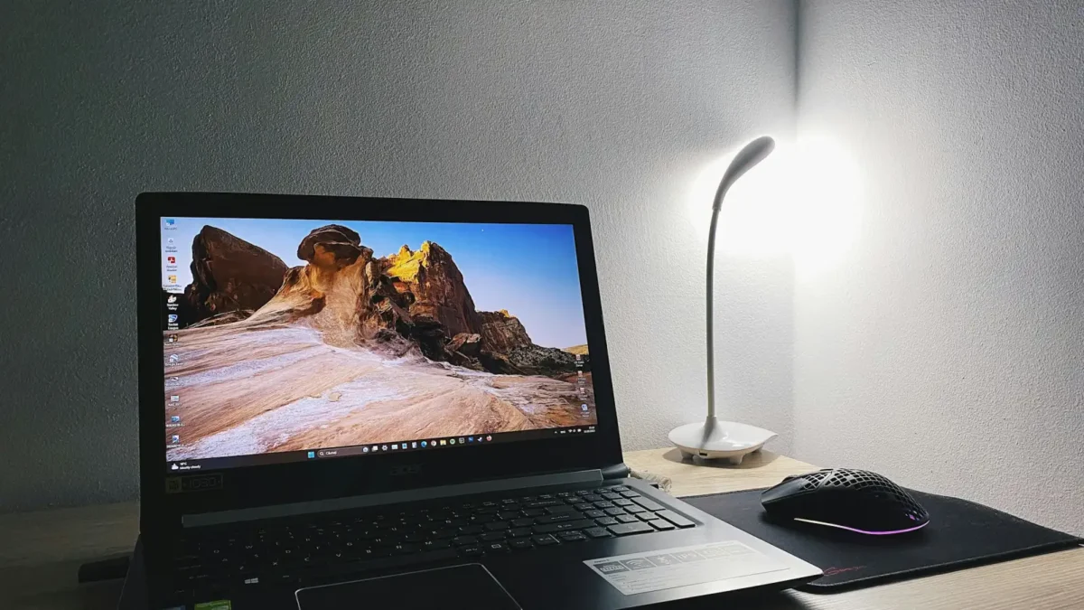Laptop on a desk showing a weekly calendar with a coffee mug beside it, for a founder deciding between Calendly vs Cal.com