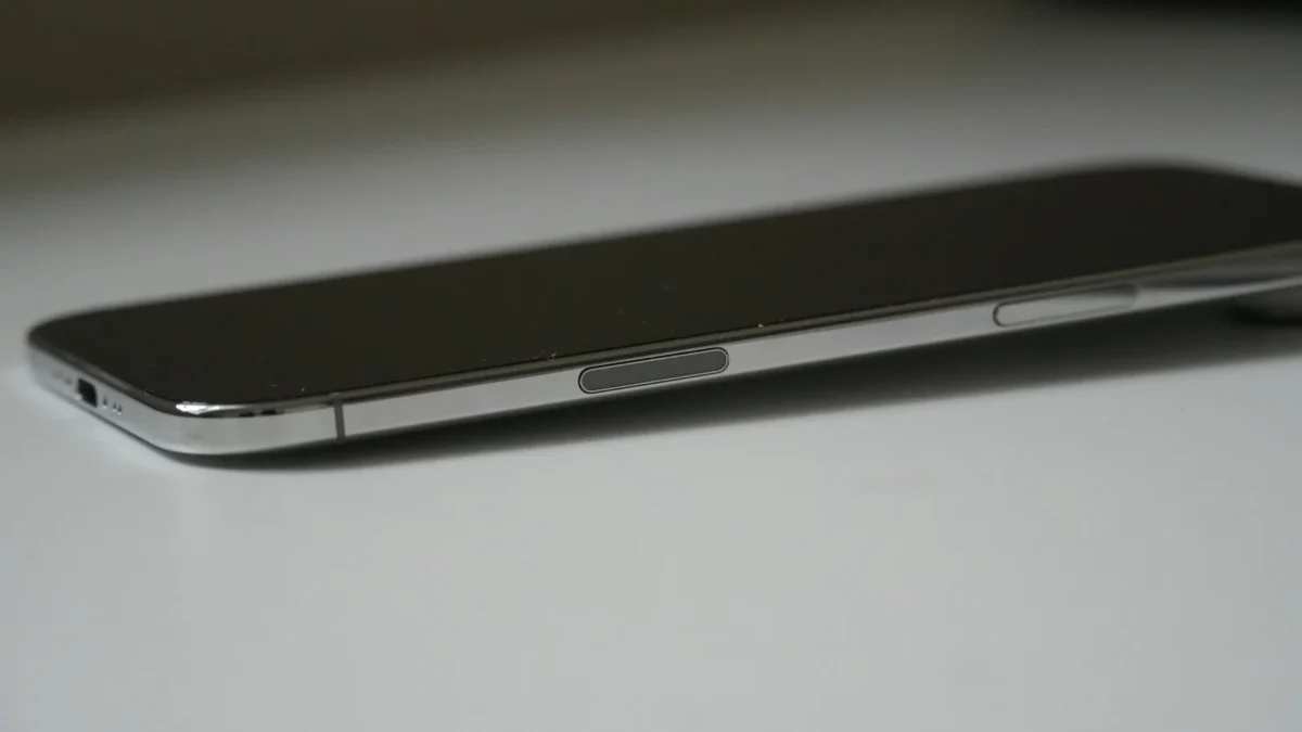 Two smartphones side by side on a wooden desk next to a notebook, comparing Setmore vs Calendly booking pages